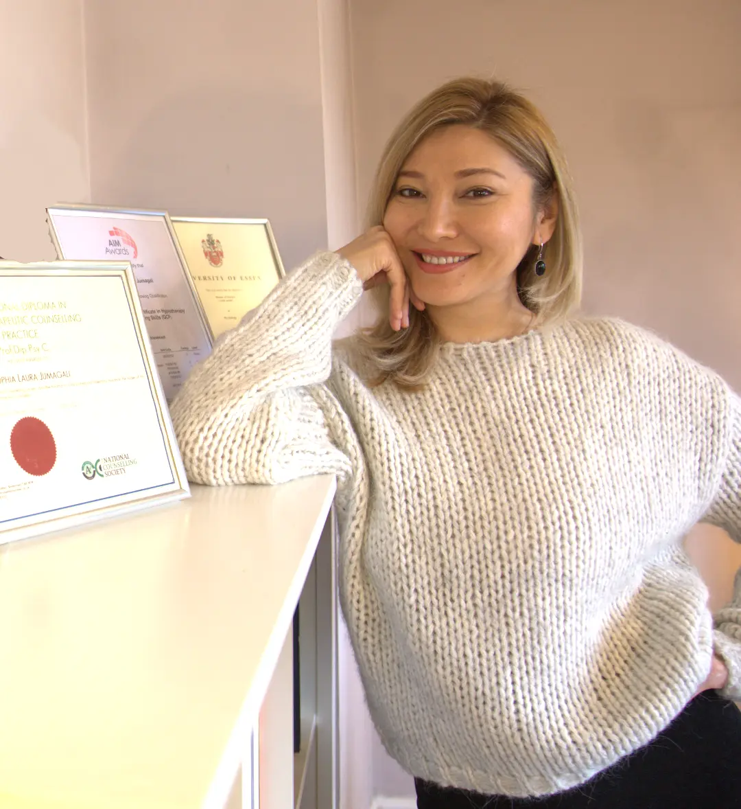 Sophia Jumagali, EMDR therapist in London, standing with her professional certifications