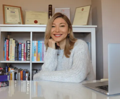 Sophia Jumagali, therapist in London, seated at her desk, offering therapy in London for adults